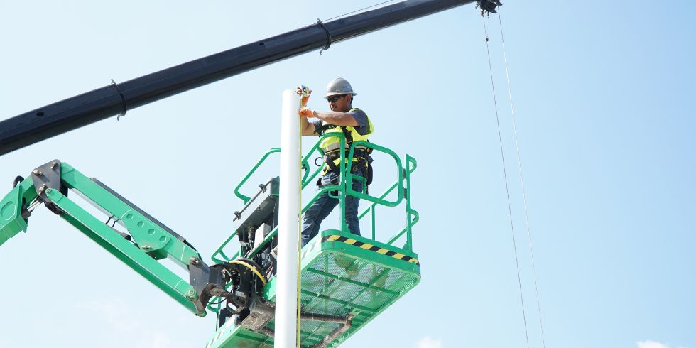 Male metalwork installation team members wearing full safety gears onsite